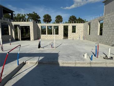 Foundation slab with block walls, under construction, shows plumbing infrastructure and window openings at 1153 Basalt Ln, Sanford, FL 32771