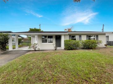 Charming single-story home featuring a carport and well-maintained front lawn at 1623 Crestlawn Ave, Orlando, FL 32811