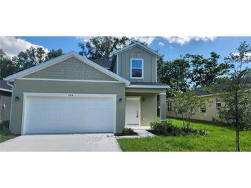 Charming two-story home featuring a well-maintained lawn and attached two-car garage at 164 14Th Ave, Longwood, FL 32750