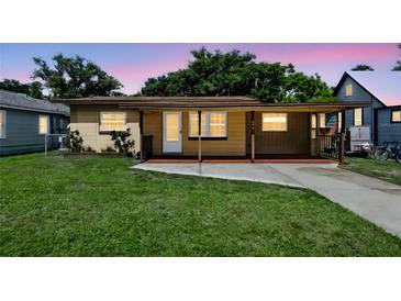 Charming single-story home with a covered porch and well-maintained lawn at 606 Ohio Ave, St Cloud, FL 34769