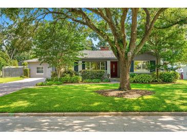 Charming single-story home featuring a well-maintained lawn and a mature shade tree in a quiet neighborhood at 927 Boardman St, Orlando, FL 32804