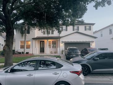 Charming two-story home with a manicured front yard, attached garage, and inviting front porch at 10148 Malpas Pt, Orlando, FL 32832