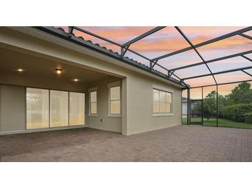 A covered patio with brick flooring, perfect for enjoying the outdoors, with a lovely sky view at 10203 Henbury St, Orlando, FL 32832