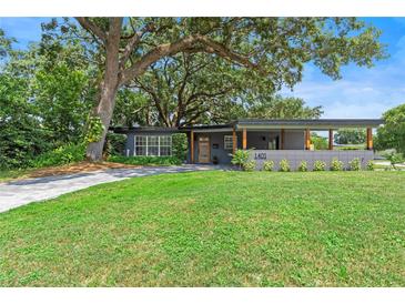 Charming single-story home boasts a manicured lawn, stylish driveway and welcoming covered entrance at 1401 Canberra Ave, Orlando, FL 32806