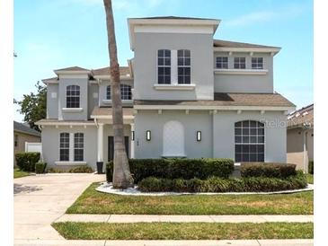 Stately two-story home featuring manicured landscaping and neutral toned exterior at 166 Minniehaha Cir, Haines City, FL 33844