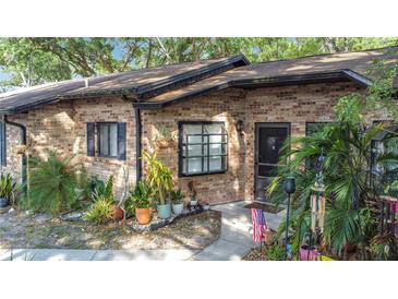 Charming brick townhome with well-maintained landscaping and inviting entrance, perfect for a cozy living space at 1803 Foxhall Cir # 1803, Kissimmee, FL 34741