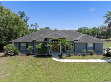 Charming single-story home with lush landscaping and a welcoming entrance at 2633 Pickett Downs Dr, Chuluota, FL 32766