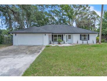 Charming single-story home featuring a well-maintained lawn and inviting front entrance at 37 N Tymber Crk, Ormond Beach, FL 32174