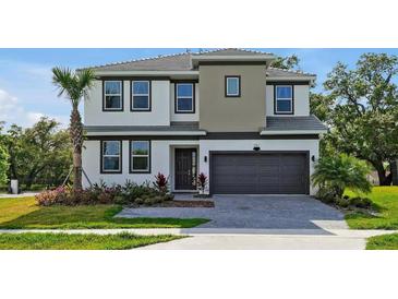 A charming two-story home boasts meticulous landscaping, a two-car garage and lush, mature landscaping at 4441 Ganesha Loop, Kissimmee, FL 34746