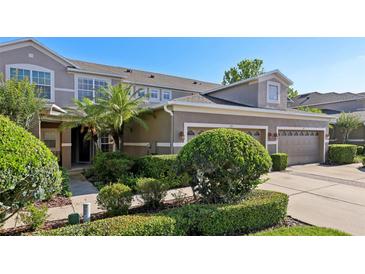 Well-maintained home featuring lush landscaping and an attached two-car garage at 585 Cruz Bay Cir, Winter Springs, FL 32708