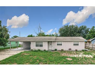 Attractive one-story home with well-kept landscaping and an attached carport on a sunny day at 116 7Th St, Winter Haven, FL 33880
