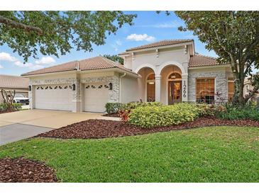 Charming single-Gathering home with a three-car garage, well-manicured lawn, and beautiful landscaping at 1266 Saint Albans Loop, Lake Mary, FL 32746