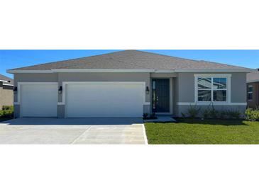 Charming one-story home with a two-car garage and well-manicured front lawn at 2080 Ashwood Bluff Dr, Ocoee, FL 34761