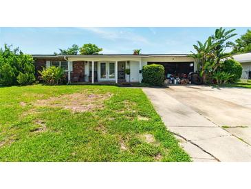 Charming single-story home with a well-maintained lawn and inviting front porch at 2504 Caribbean Ct, Orlando, FL 32805