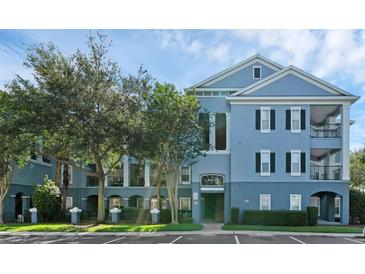 Attractive two-story condo building with well maintained landscaping and on-site parking at 3561 Conroy Rd # 216, Orlando, FL 32839