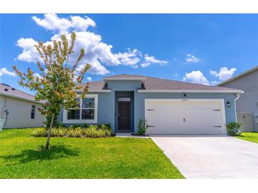 Charming one-story home featuring a two-car garage, well-maintained lawn, and inviting curb appeal at 3723 Alder Bark Ln, Sanford, FL 32773
