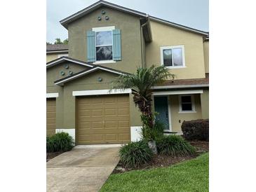 Inviting townhome with a well-maintained front yard and an attached garage at 626 Old Pine Ct, Sanford, FL 32773