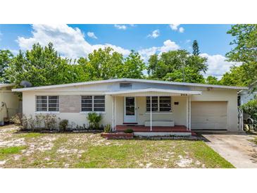 Charming single-story home with a covered porch and well-maintained front yard at 944 Essex Rd, Daytona Beach, FL 32117