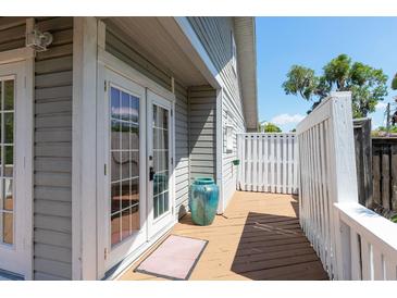 Wooden deck featuring french doors, white railings, and a light grey house exterior at 1308 S Pennsylvania Ave # 3, Winter Park, FL 32789
