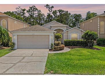 Charming single-story home features a two-car garage, landscaped yard, and beautiful curb appeal at 14780 Hartford Run Dr, Orlando, FL 32828