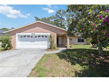 Charming single-story home features an attached two-car garage and well-maintained lawn at 4806 Gallant Ln, Orlando, FL 32821