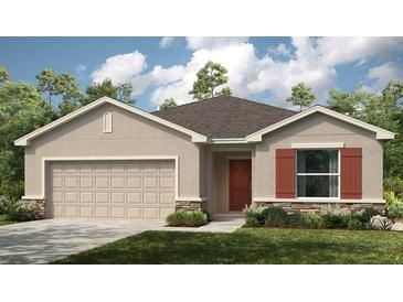 Charming single-story home with a two-car garage, lush landscaping, and a welcoming front entrance at 4859 Sunflower St, Lake Hamilton, FL 33851