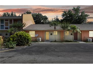 Inviting condo exterior with tropical landscaping and assigned parking at 4878 Tangerine Ave # 4878, Winter Park, FL 32792