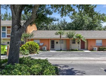 Cozy townhome featuring neutral paint, well maintained landscaping, and a parking area at 4878 Tangerine Ave # 4878, Winter Park, FL 32792