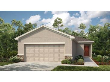 Charming single-story home with a two-car garage and a beautifully landscaped front yard at 5117 Forget Me Not Ave, Lake Hamilton, FL 33851