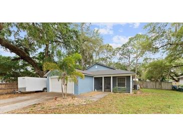 Charming single-story home with a well-maintained lawn and mature trees for shade at 6436 Fig Leaf St, Magnolia Square, FL 34771