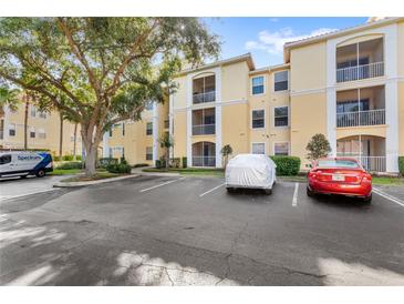 Multi-story condo building with ample parking, mature landscaping, and screened-in balconies at 1325 Lake Shadow Cir # 12303, Maitland, FL 32751