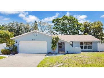 Charming single-story home featuring a well-maintained lawn, two-car garage, and a beautifully painted exterior at 3217 Castle Oak Ave, Orlando, FL 32808
