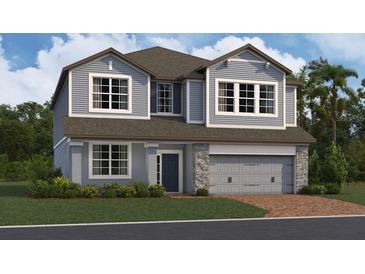 Charming two-story home with stone accents, a two-car garage, and well-maintained landscaping at 809 River Stone Trl, Sanford, FL 32771