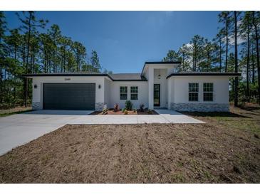 Beautiful single-Gathering home boasting a modern design, manicured lawn, and attached two car garage at 13419 Sw 77Th Ave, Ocala, FL 34473