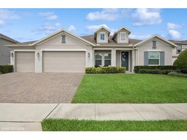 Charming one-story home featuring a three-car garage and well-manicured front lawn at 1835 Southern Red Oak Ct, Ocoee, FL 34761