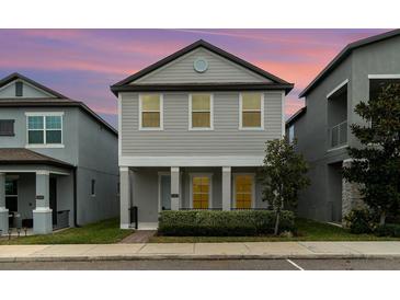 Charming two-story home featuring a symmetrical design and manicured front yard, offering an inviting curb appeal at 1997 Standing Rock Cir, Oakland, FL 34787