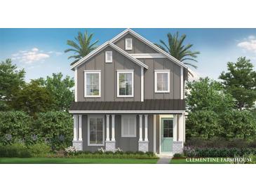 Charming two-story home featuring board and batten siding, a metal roof, and a welcoming front porch at 2054 Education St, St Cloud, FL 34771