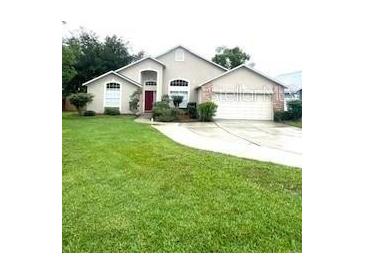 Charming one-story home features a well-manicured lawn and attached two-car garage at 300 Churchill Dr, Longwood, FL 32779