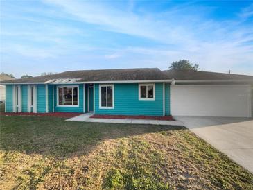 Charming single-story home with a well-manicured lawn and a two-car garage at 3321 Crimson Ln, Deltona, FL 32738