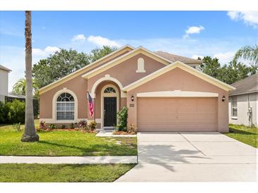 Charming single-story home with a well-manicured lawn and a two-car garage at 4249 Andover Cay Blvd, Orlando, FL 32825