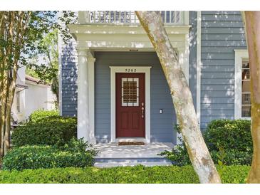 Charming home featuring a red front door, manicured landscaping, and a welcoming entrance at 5262 Baskin St, Orlando, FL 32814
