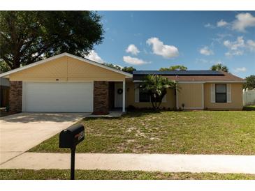 Charming single Gathering home featuring a well-manicured front yard and solar panels at 5547 Garden Grove Cir, Winter Park, FL 32792