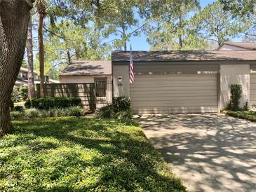 Charming home features a two-car garage and lush landscaping in a well-maintained community at 650 Woodridge Drive, Fern Park, FL 32730