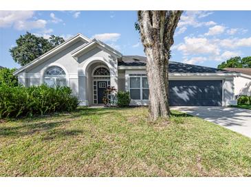 Charming single-story home with a well-maintained lawn and beautiful front yard landscaping at 1013 Silcox Branch Cir, Oviedo, FL 32765