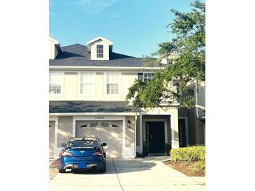 Two-story home boasting attached garage, well-manicured landscaping, and neutral color scheme in desirable community at 14033 Turning Leaf Dr, Orlando, FL 32828