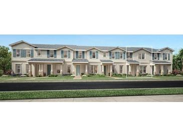 Charming row of new two-story townhomes, each boasting unique architectural details and manicured lawns at 1828 Crowncrest Dr, Apopka, FL 32703