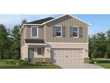 Charming two-story home with gray accents, shutters, and a two car garage at 4066 Old Mill Rd, Haines City, FL 33844