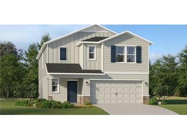Charming two-story home with a well-maintained lawn and a two-car garage at 4070 Old Mill Rd, Haines City, FL 33844