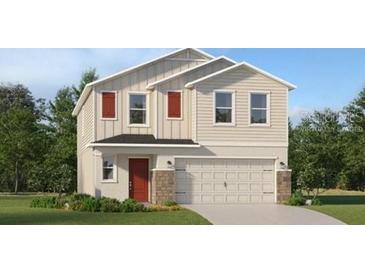 Charming two-story home featuring a two-car garage, red door, and a well-maintained lawn with shrubbery at 4078 Old Mill Rd, Haines City, FL 33844