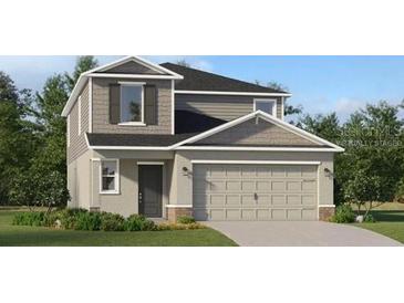 Charming two-story home showcasing a gray color scheme, attached two-car garage, and professionally landscaped yard at 4082 Old Mill Rd, Haines City, FL 33844